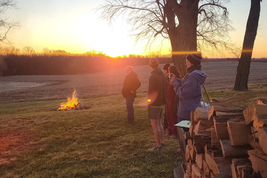 group outside near fire at wellness retreat in missouri